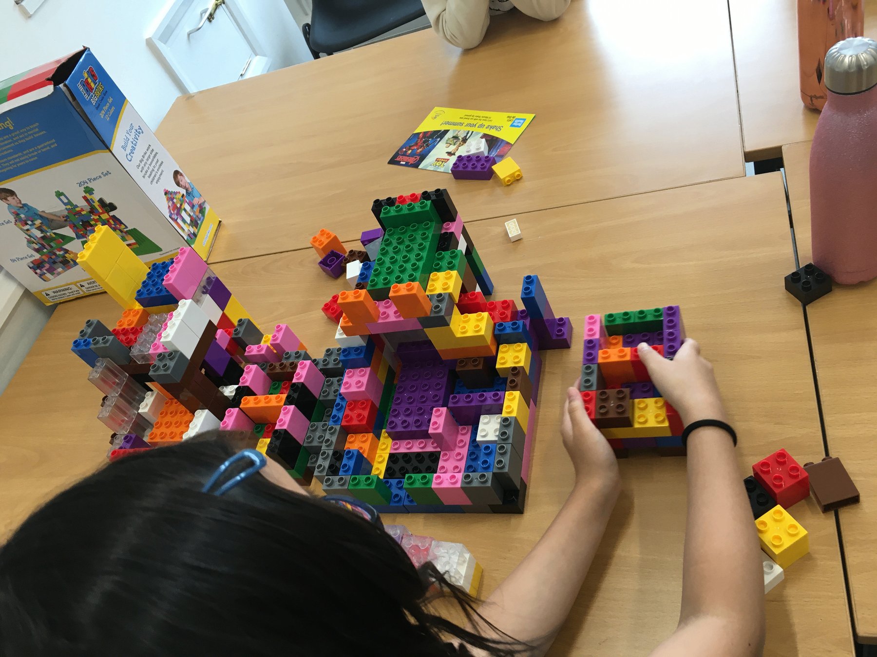 A pupil building an elaborate construction-brick model